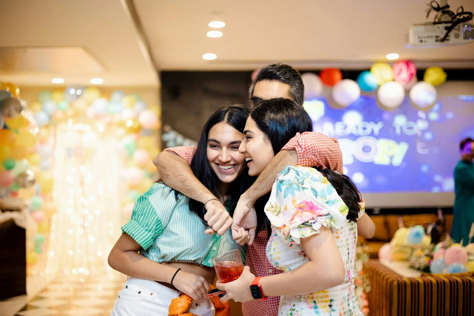Guests laughing together around a celebration table