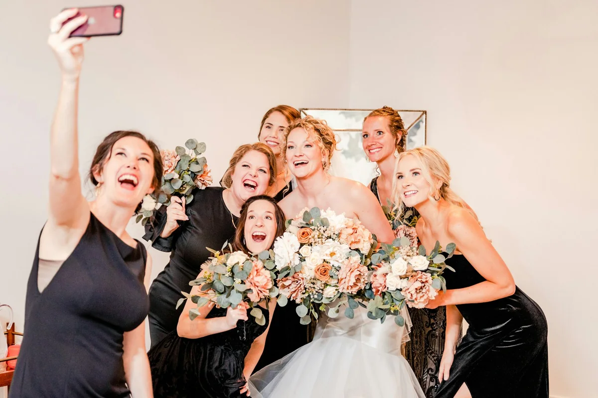 A bride and friends taking a group selfie