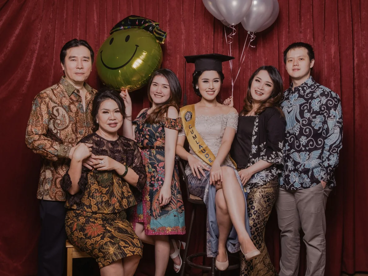 A graduate celebrating with family