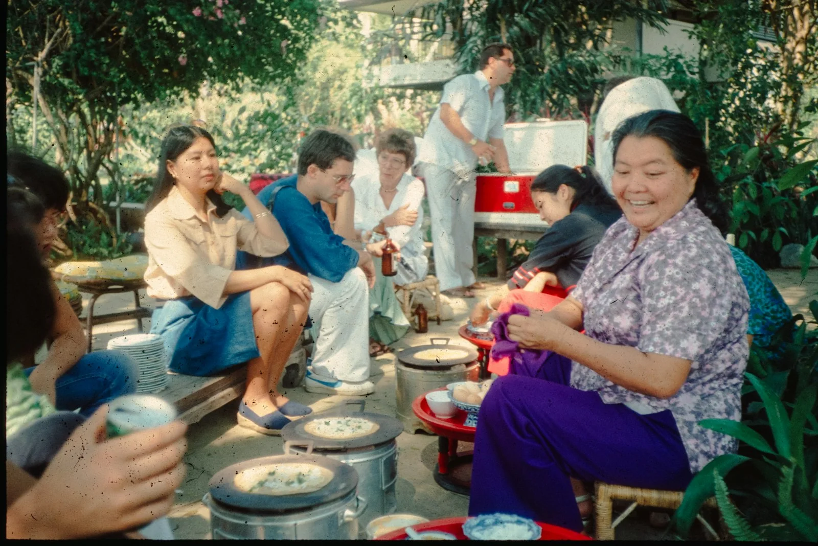 Family and friends laughing together around a table