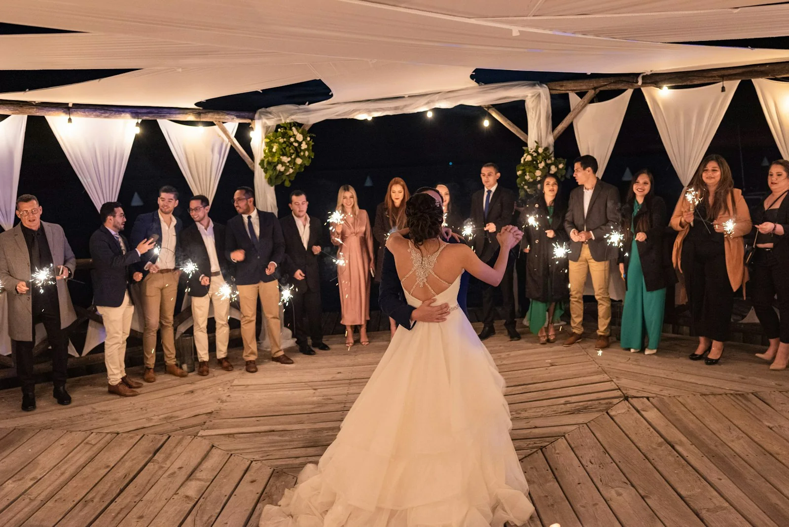 Wedding guests dancing during a warmly lit reception